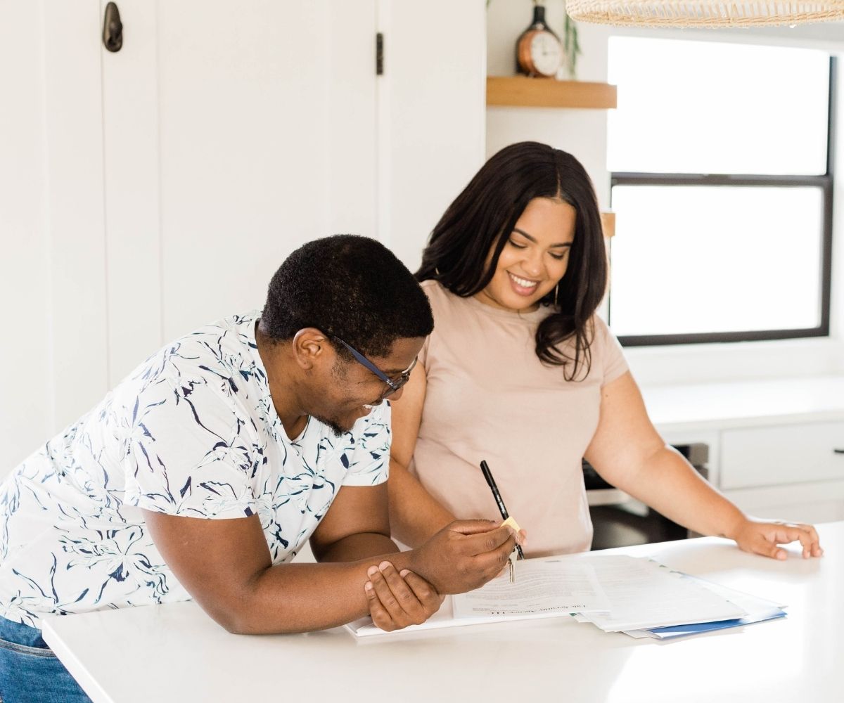 Couple signing paperwork