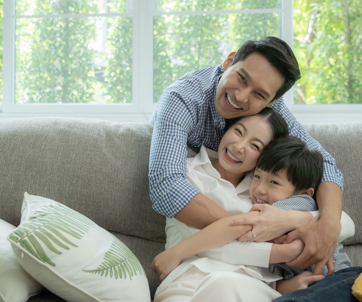 Family hugging on couch