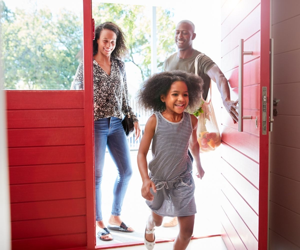 Family walking in a front door