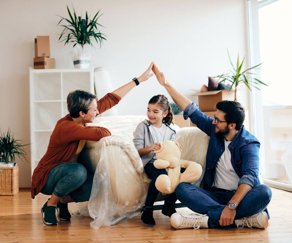 Man and Woman with girl holding teddy bear