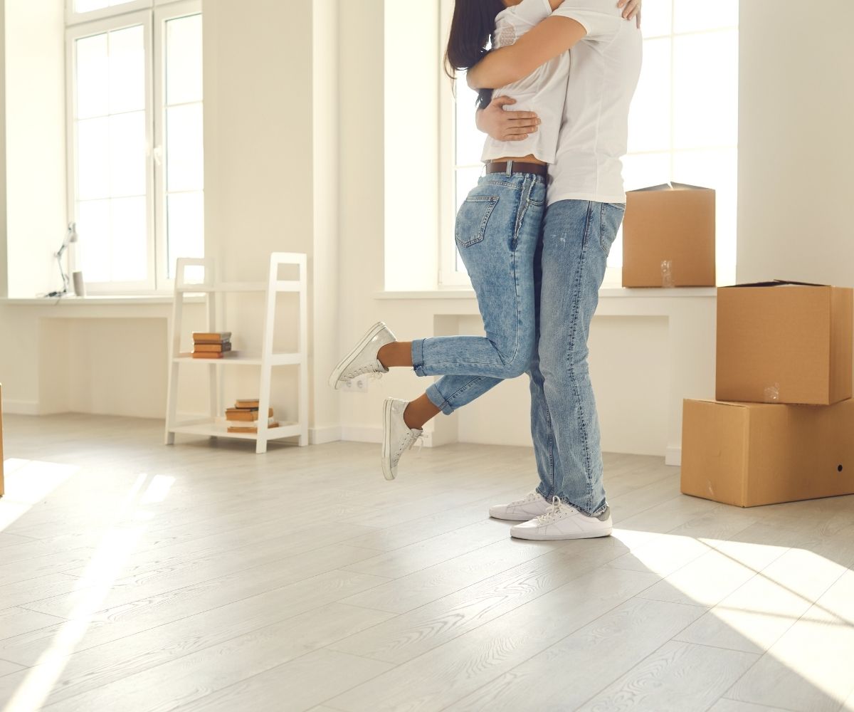 Two people hugging with moving boxes