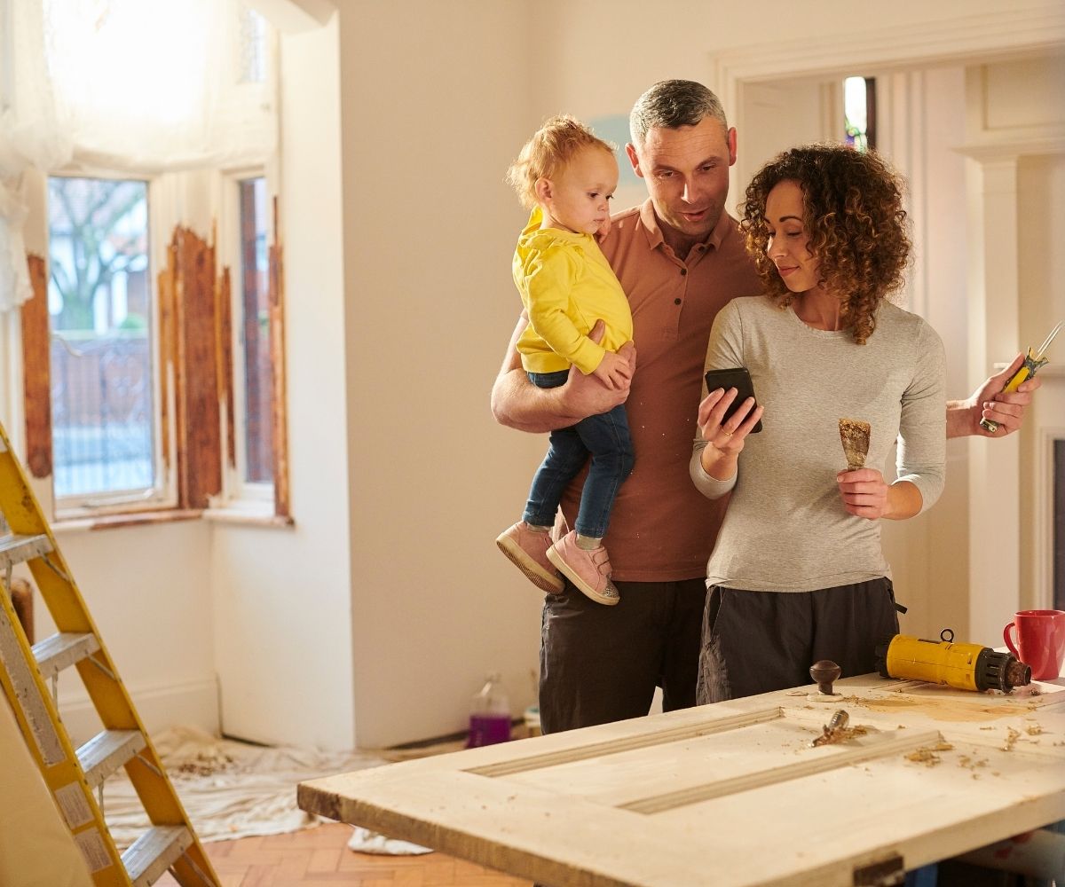 Family doing renovations looking at a phone